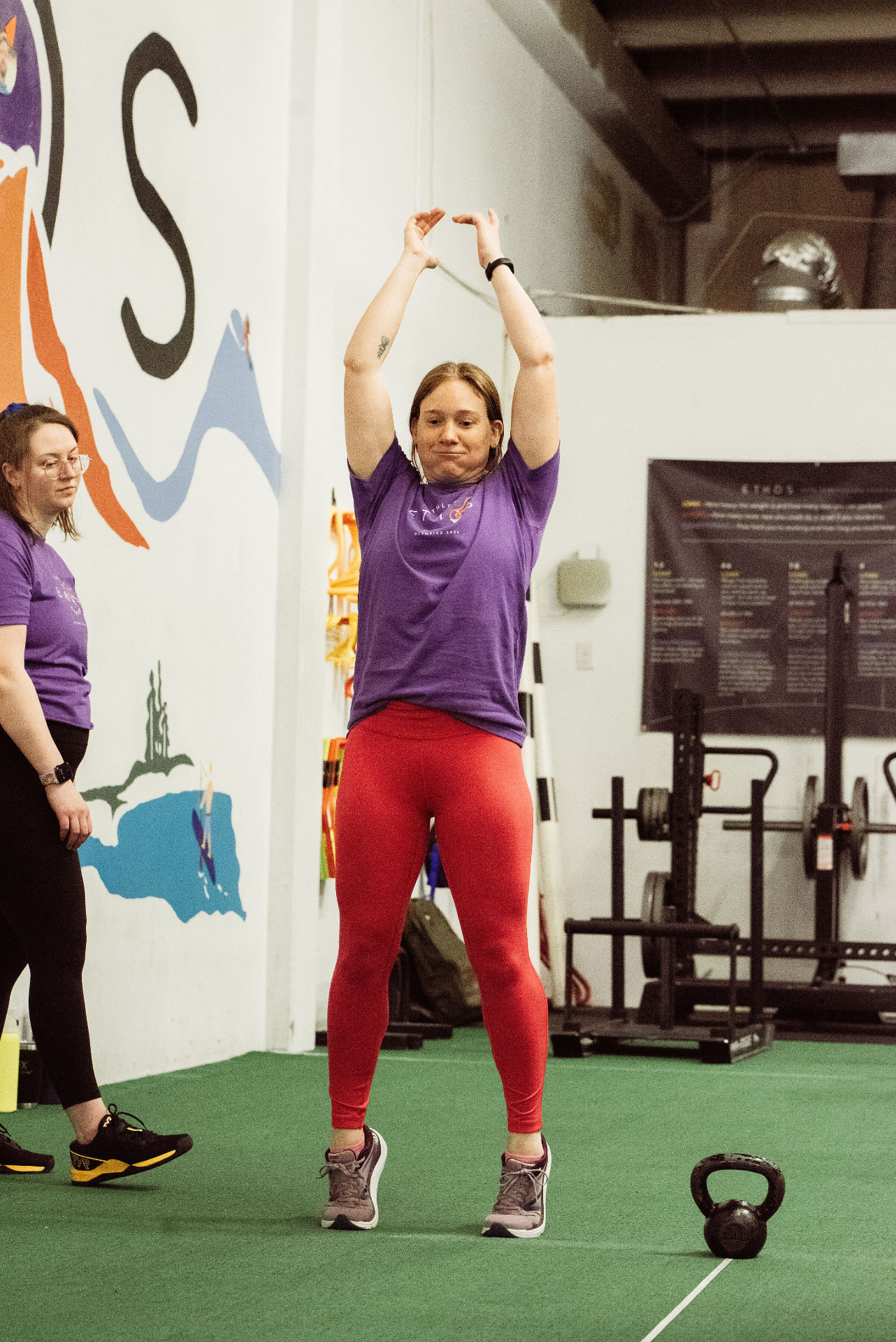 A woman warming up with overhead reaches during a LiftHer session