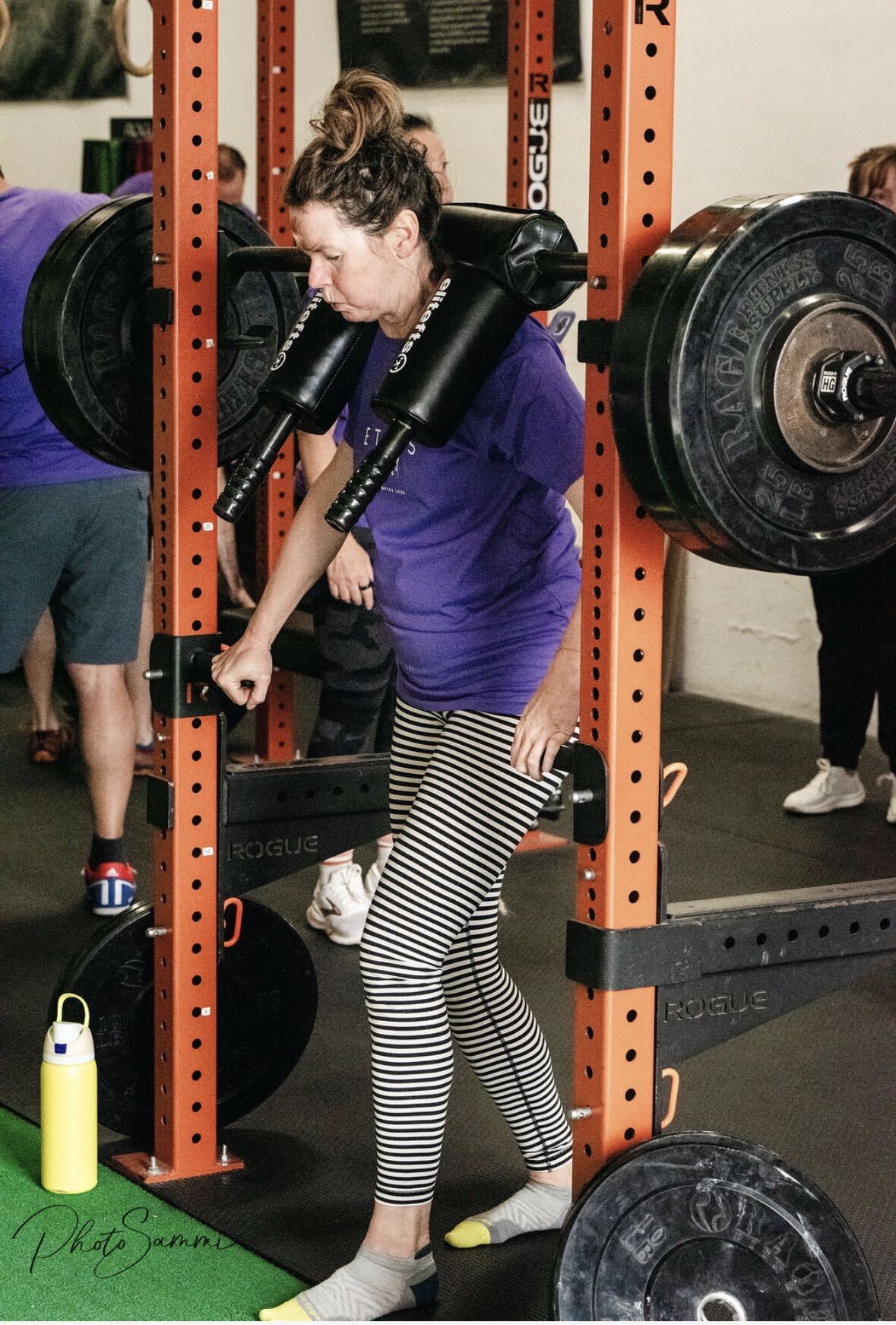 An Ethos Colorado member unracking a loaded barbell for squats